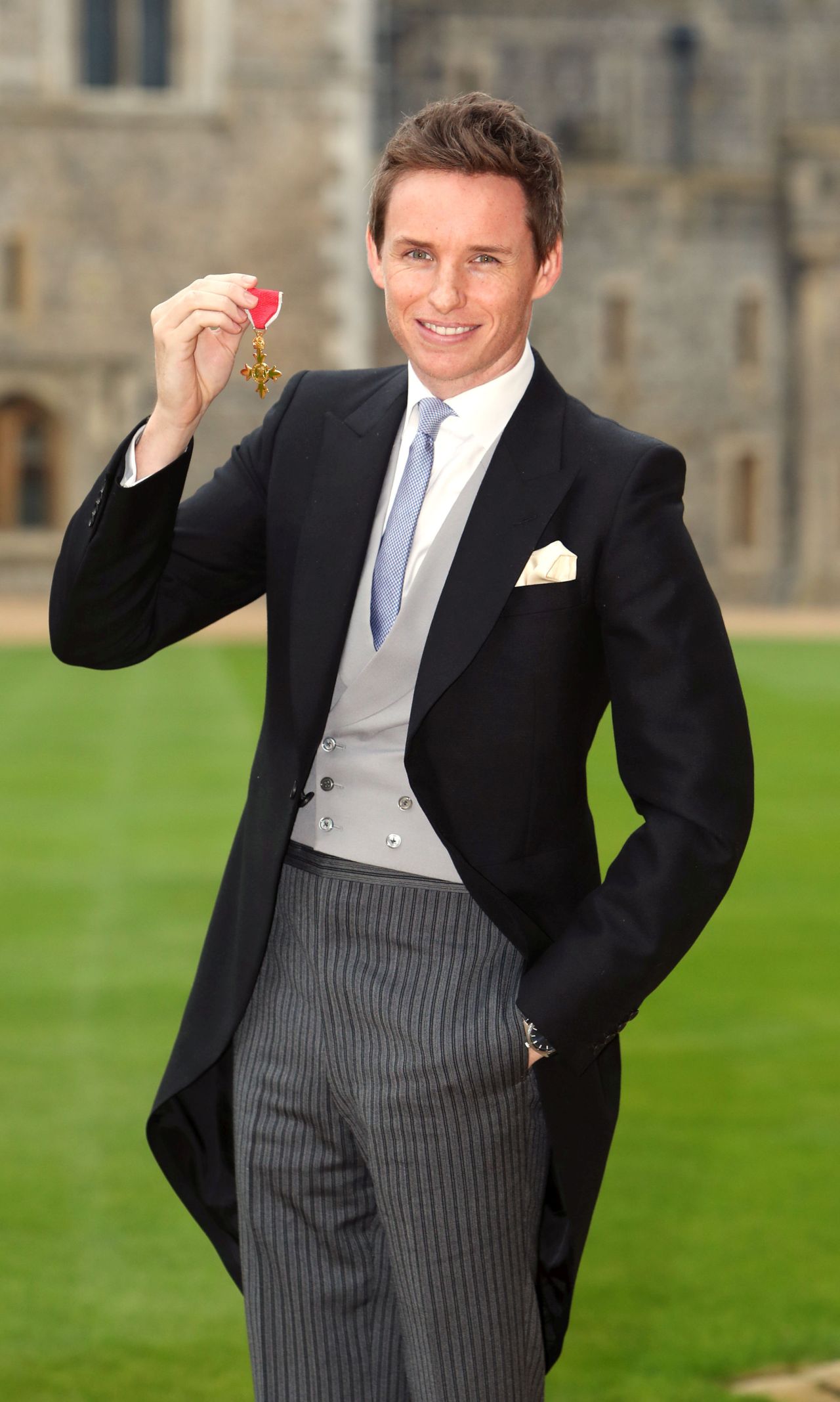 WINDSOR ,ENGLAND - DECEMBER 2: Eddie Redmayne poses after he was made an OBE (Officer of the Order of the British Empire) by Queen Elizabeth II during an investiture ceremony at Windsor Castle on December 2, 2016 in Windsor, England. (Photo by Steve Parsons-WPA Pool/Getty Images)